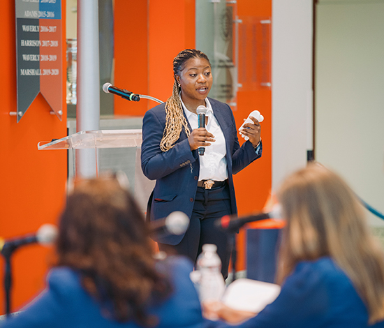 Student presenting in front of judges in Flaum Grand Hall