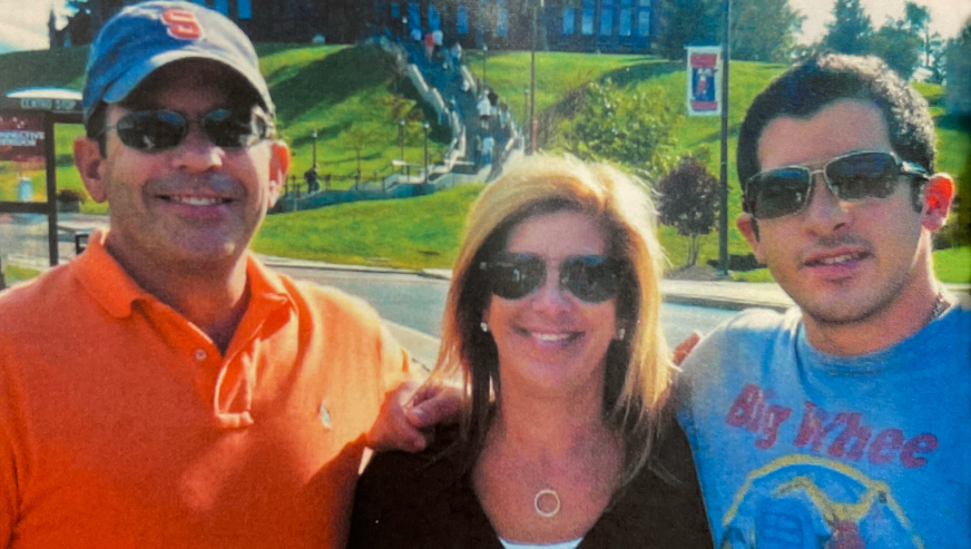Jason Cole posing on campus with his parents