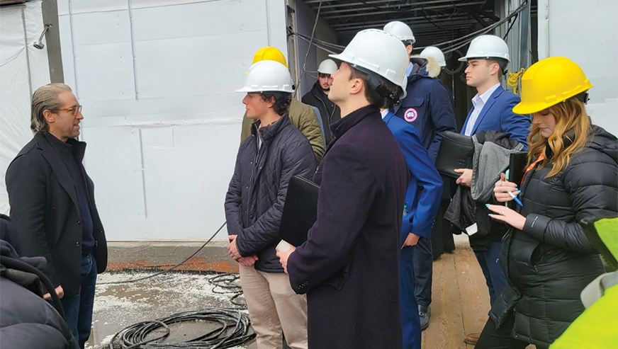 Real estate students wearing hard hats during the sitevisit to Slate Property Group