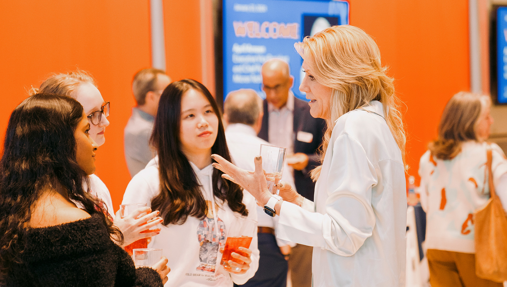 April Arnzen speaking with student in Flaum Grand Hall