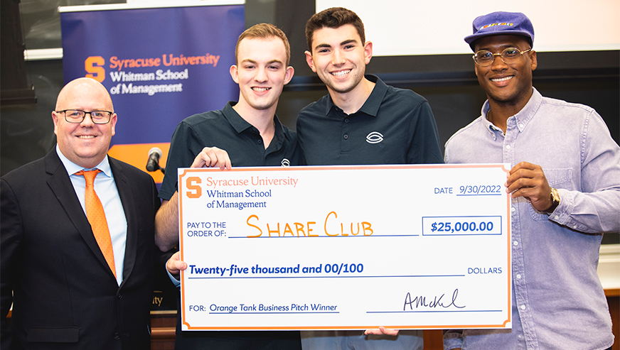 Winning Orange Tank team posing with Alex McKelvie and Derrell Smith