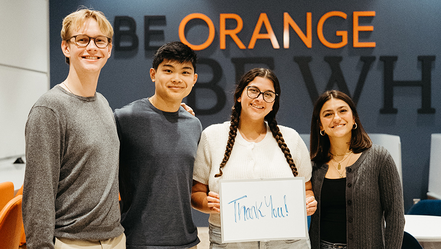 Students posing holding a thank-you-sign