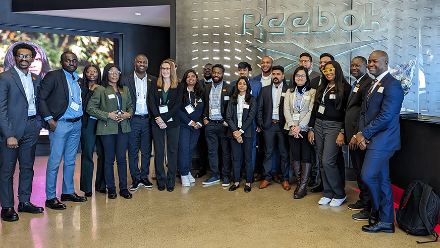 Students posing in front of Reebok sign