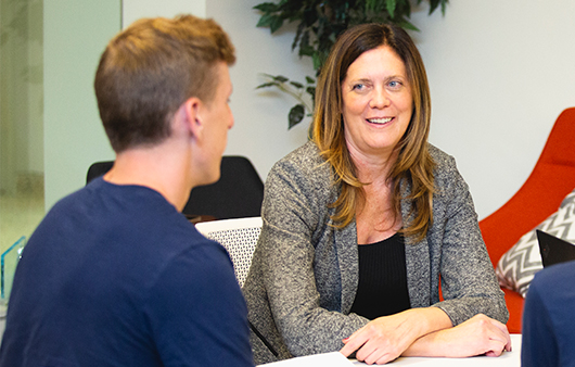 Susan Albring talking with a student